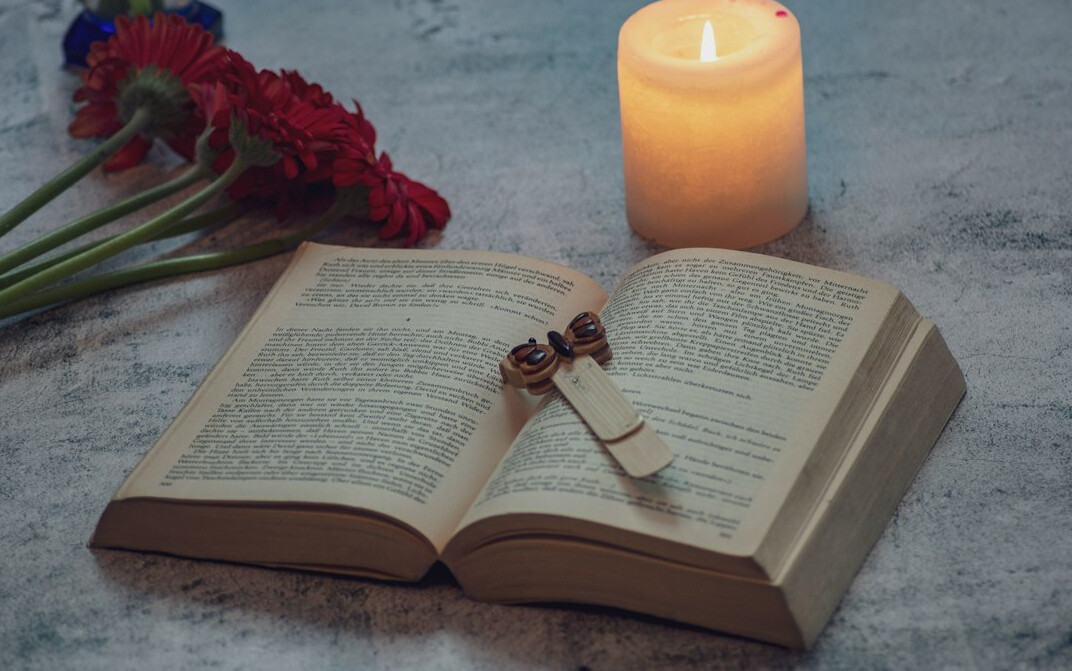 Mystery novel book beside a candle and old key